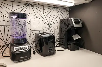 a blender sitting on a counter next to a printer at Studio Apartment in the Philadelphia in Philadelphia