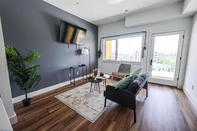 a living room with a couch and a table at StudioAprt QueenBed,WiFi,WD,Parking,Gym in Philadelphia