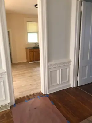an empty room with a white door and wooden floors at Home Support And Care LLC in Binghamton