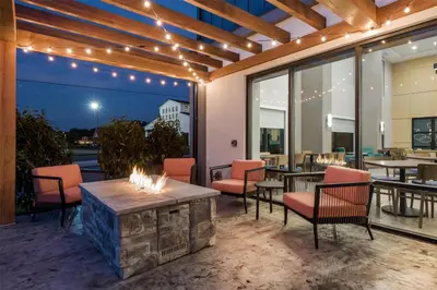 a patio with a fireplace and chairs and tables at Hampton Inn & Suites Intercourse, Pa in Intercourse
