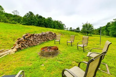 a group of chairs sitting around a fire pit at Mtn-View Deck and Grill Creekside Catskills Cabin! in Equinunk