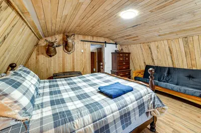 a bedroom with a bed and a couch in a room at Mtn-View Deck and Grill Creekside Catskills Cabin! in Equinunk