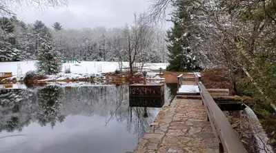 a body of water with snow on the ground at Gorgeous house private pool hot tub playroom in Long Pond