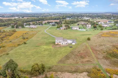 an aerial view of a large field with a house at 10 Acre Hidden Gem in Dillsburg