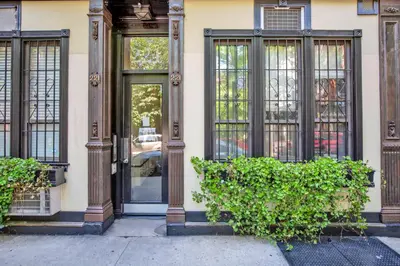 a building with a door and some plants in front at Blueground Nolita wd ac nr Little Italy NYC-1570 in New York