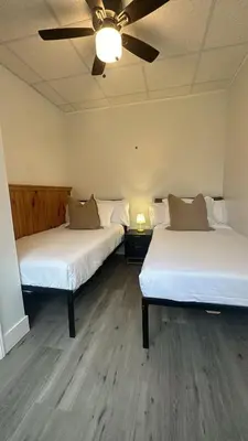 two beds in a room with a ceiling at Peaceful Paradise , Dream Holiday Home in Woodridge in Mountain Dale