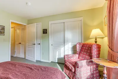 a living room with a chair and a table at Less Than 1 Mi to Mountain Creek Resort Condo with Balcony in Vernon Township