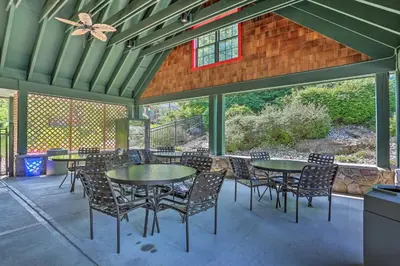 a patio with tables and chairs and a butterfly at Less Than 1 Mi to Mountain Creek Resort Condo with Balcony in Vernon Township
