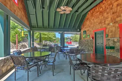 a patio with tables and chairs in a restaurant at Less Than 1 Mi to Mountain Creek Resort Condo with Balcony in Vernon Township