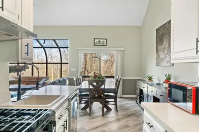 a kitchen with a table and a dining room at Mountain Creek Townhouse in Vernon Township