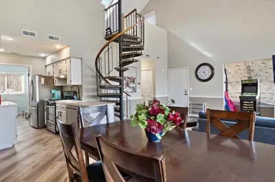 a dining room table with a vase of flowers on it at Mountain Creek Townhouse in Vernon Township