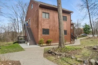 a wooden house with a tree in front of it at Mountain Creek Townhouse in Vernon Township