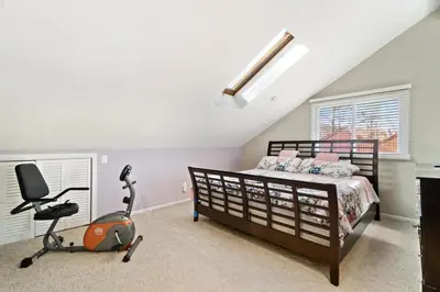 a bedroom with a bed and a desk and a treadmill at Mountain Creek Townhouse in Vernon Township