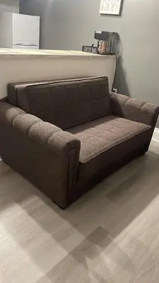 a brown couch sitting in a living room at The Luxe Nook, Premier Studio in Scenic Congers in Congers