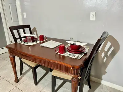 a dining room table with red dishes on it at Cozy 1 BR, walk to subway, Free WiFi & Parking in Belleville