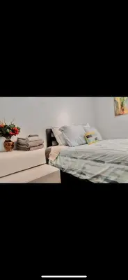 a bedroom with a bed with a plant on it at Stylish Urban Getaway 3BR 2BA Patio Oasis Near NYC, EWR & American Dream Mall in Newark