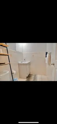 a bathroom with a sink and a toilet and a ladder at Stylish Urban Getaway 3BR 2BA Patio Oasis Near NYC, EWR & American Dream Mall in Newark