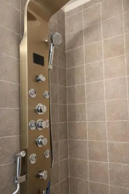 a shower in a bathroom with a glass door at Tremont Hidden Treasure in East Orange