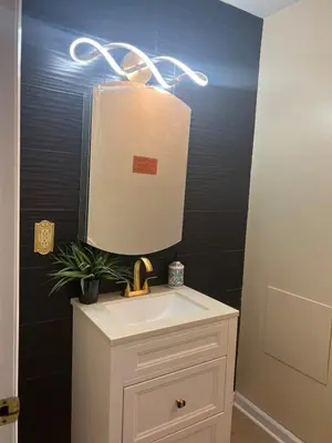 a bathroom with a white sink and a mirror at Tremont Hidden Treasure in East Orange
