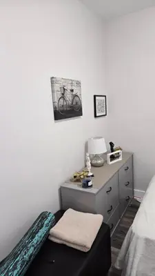 a bedroom with a bed and a desk with a bike on the wall at Serenity Haven in Irvington