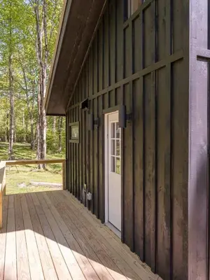 a door on the side of a wooden building at Modern Rustic Tiny Home in the Catskills in Roscoe