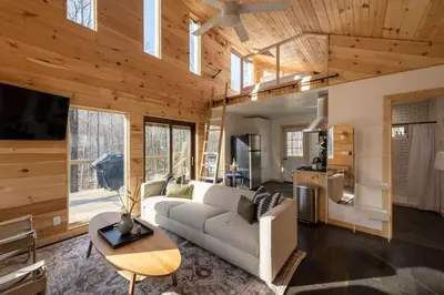 a living room with a couch and a table at Modern Rustic Tiny Home in the Catskills in Roscoe