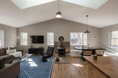 a living room with a couch and a table at Private Cabin with Guesthouse Hot Tub Fire Pits in Roscoe