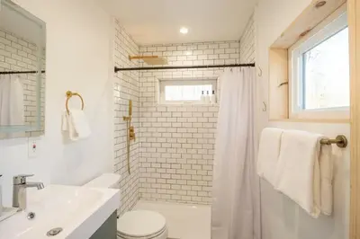 a bathroom with a sink and a toilet and a shower at Private Cabin with Guesthouse Hot Tub Fire Pits in Roscoe