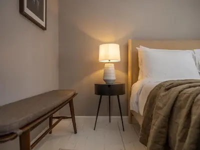a bedroom with a bed and a lamp on a table at Private Cabin with Guesthouse Hot Tub Fire Pits in Roscoe