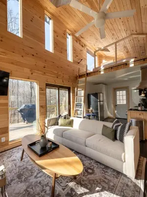 a living room with a white couch and a table at Private Cabin with Guesthouse Hot Tub Fire Pits in Roscoe