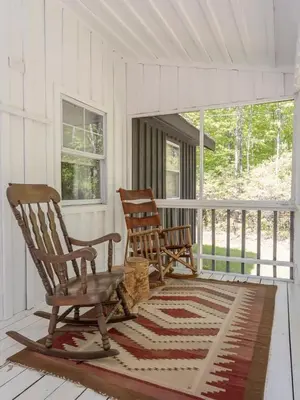 two rocking chairs on the porch of a house at Chic Cabin with Hot Tub and Fire Pit in Roscoe