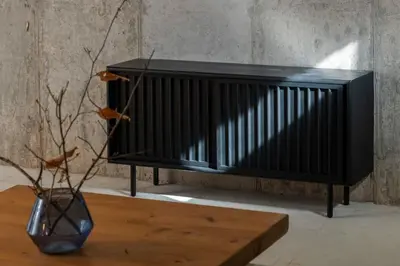 a black bench next to a wooden table and a vase at Chic Cabin with Hot Tub and Fire Pit in Roscoe