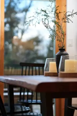 a wooden table with a vase with a plant in it at Private Chalet with Fire Pit Deck and Large Yard in Roscoe