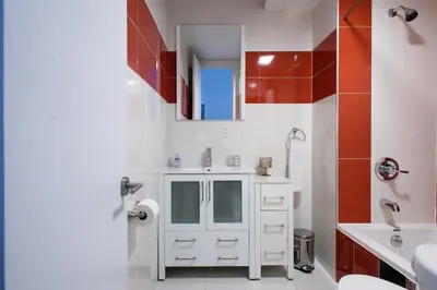 a white bathroom with a sink and a toilet at 24-10 Studio in Prime Gramercy WD in Unit in New York