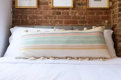 a bed with a pillow with stuffed animals on it at 24-10 Studio in Prime Gramercy WD in Unit in New York