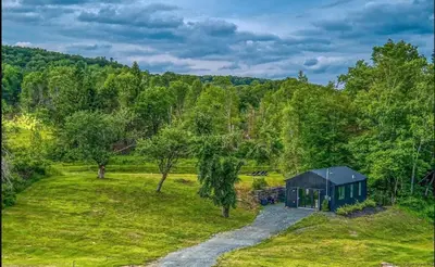 an overhead view of a green cabin in a field at Chic Renovated Chalet with Private Pond in Roscoe