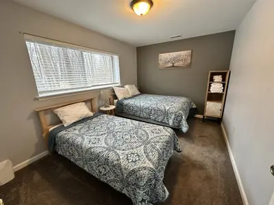 a bedroom with two beds and a window at Iron Hill in Lake Harmony