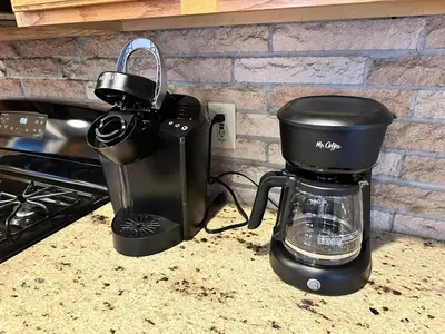 a coffeemaker and a coffee maker sitting on a counter at Iron Hill in Lake Harmony