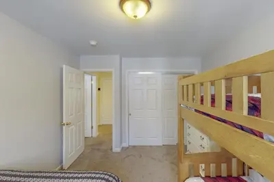 a bedroom with a bunk bed and a hallway at Iron Hill in Lake Harmony