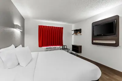 a hotel room with a bed and a flat screen tv at Studio 6 King of Prussia PA Philadelphia in King of Prussia