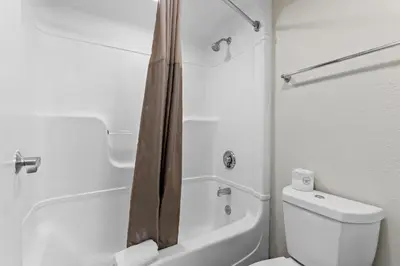 a white bathroom with a shower and a toilet at Studio 6 King of Prussia PA Philadelphia in King of Prussia