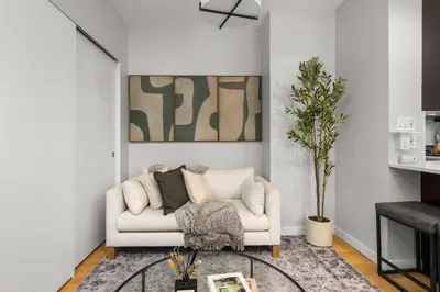 a living room with a white couch and a table at Beautiful Apartment in NYC in New York