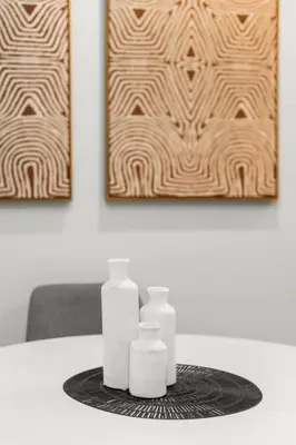 a table with two white candles on a table with paintings at Beautiful Apartment in NYC in New York