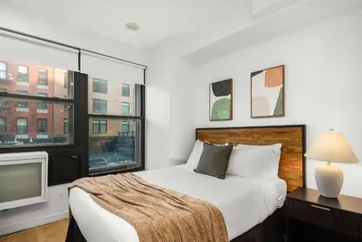 a bedroom with a bed and a tv at Beautiful Apartment in NYC in New York