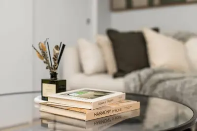 a stack of books on a glass table in a living room at Beautiful Apartment in NYC in New York