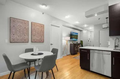 a kitchen with a table and chairs in a room at Beautiful Apartment in NYC in New York
