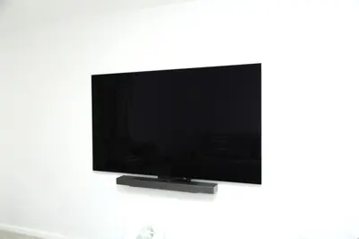 a flat screen tv hanging on a white wall at Spacious 3 Bedroom, 15 Min to EWR Airport and Parks in Newark