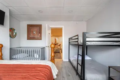 a bedroom with a bed and a bunk bed at The Grand Retreat 9BR 4BA Near NYC and Airport in Bayonne