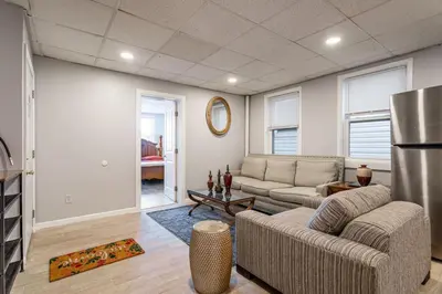 a living room with a couch and a table at The Grand Retreat 9BR 4BA Near NYC and Airport in Bayonne