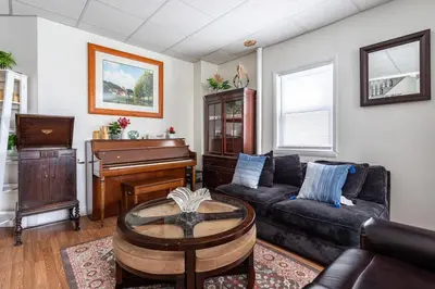 a living room with a couch and a piano at Deluxe 4BR 2BA Apartment Near NYC and Airport in Bayonne